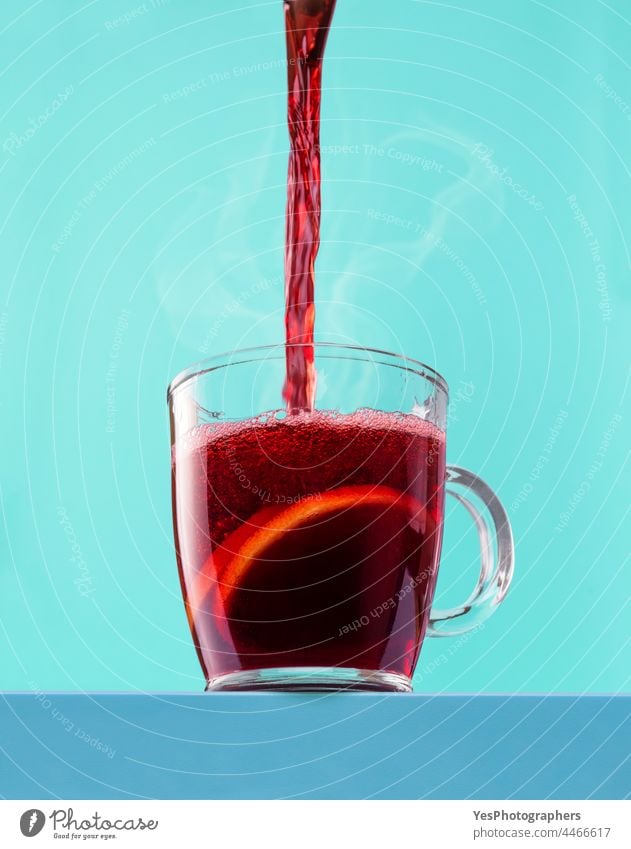 Pouring hot mulled wine into the cup. Hot red wine in a glass mug. advent alcohol angle aroma autumn background beverage blue celebration christmas close-up