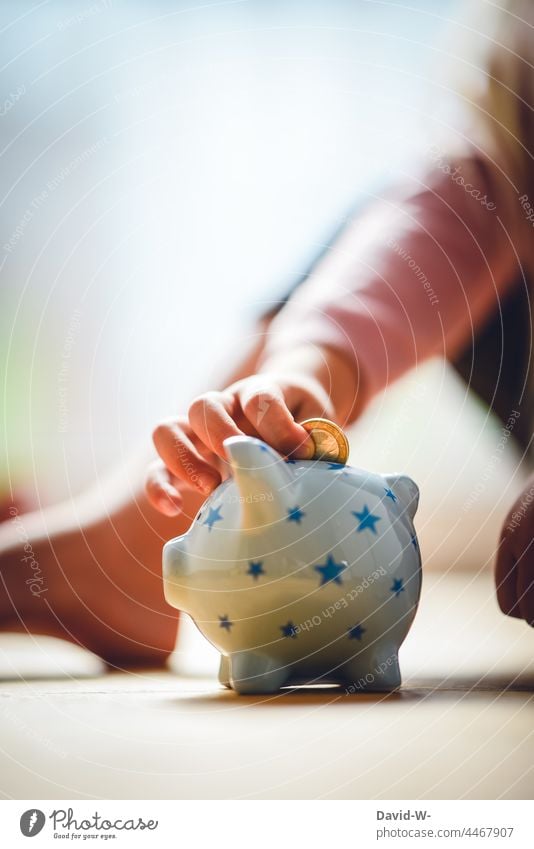 Child throws a euro into a piggy bank - concept - save Save Parenting Money box Future Euro coin To plunge Pocket money Infancy Hand