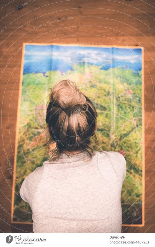 Woman in front of a map plans the holiday. Where is the trip going? Map vacation planning travel Adventure Anticipation Preparation Planning splayed Euphoria