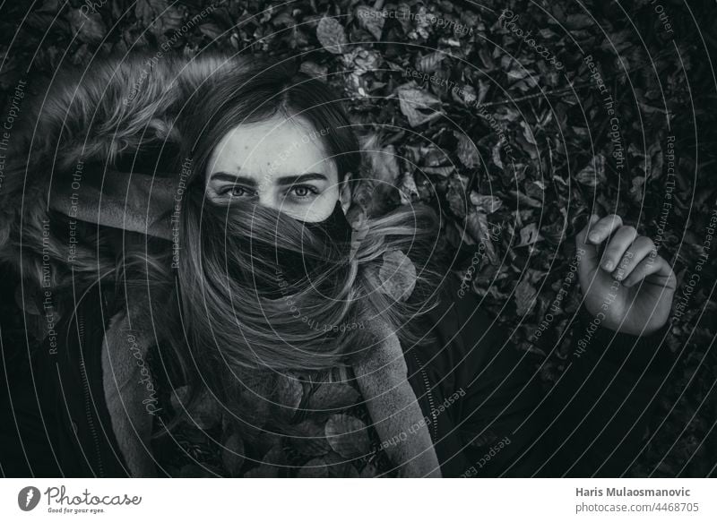 black and white girl with face mask laying on the ground alone autumn autumn leaves autumn vibes background beautiful beautiful woman caucasian celebration