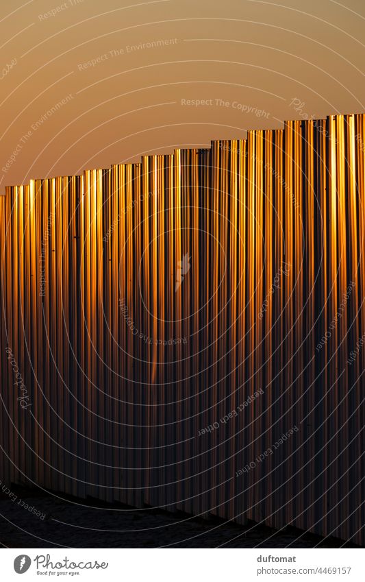 golden sun rays reflection on corrugated sheet metal Corrugated sheet iron Hoarding Pattern Sun Sunset sunset mood Tin Corrugated iron roof Reflection Gold