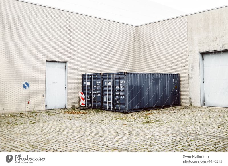 Containers stand in a corner in front of halls Exterior shot Colour photo Metal Deserted Logistics Port City Harbour Construction site Container terminal Trade