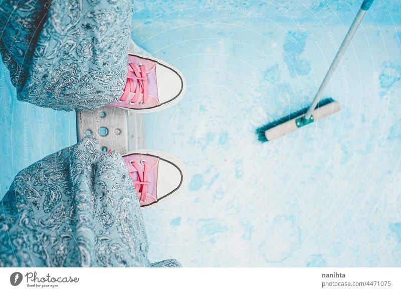 High angle view of a young woman legs in an empty pool feet blue pink background abstract high perspective sneakers opposites cool cold tones trendy texture