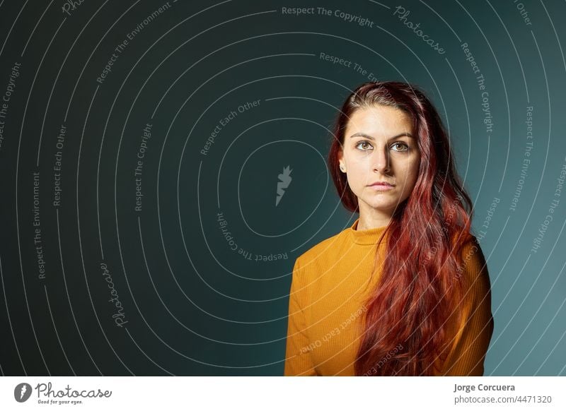 attractive and red-haired young Caucasian woman with orange jersey and great copy space 20 old background white girl happy makeup portrait pretty student age