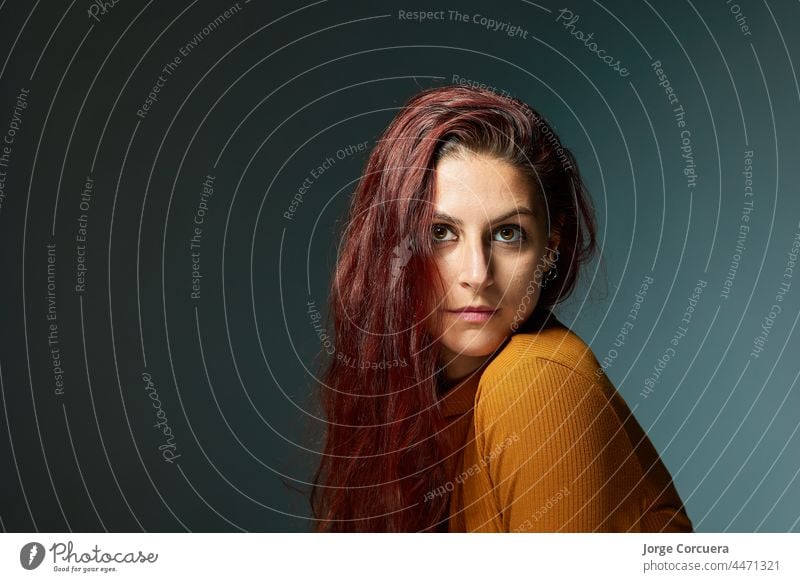 portrait of a Caucasian woman with a beautiful red hairstyle surrounding her head. casual gesture hands redhead skin wavy lips camera confident attractive cool