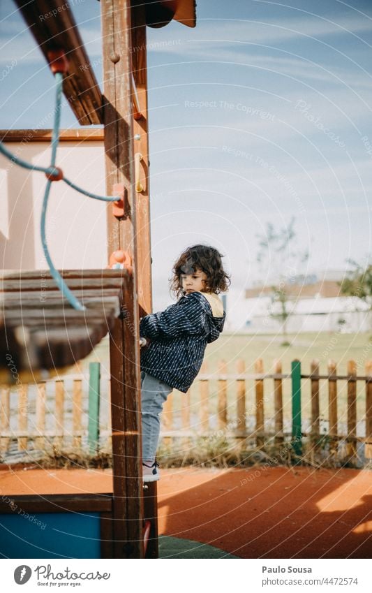 Side view girl playing at playground Child one person Caucasian Girl 1 - 3 years Playing Playground School playground equipment Infancy Exterior shot