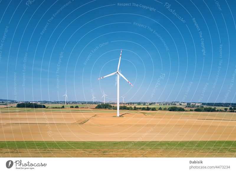 Windmill turbine in the field at summer day. Rotating wind generator energy windmill technology propeller sustainable landscape eco electric concept industry