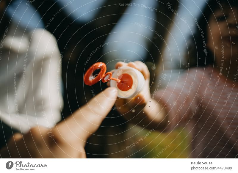 Close up finger touching soap bubble Soap bubble Close-up Fingers Bubble Water Blow Foam Blue Air Colour photo soapy water Joy Round Playing Child childhood