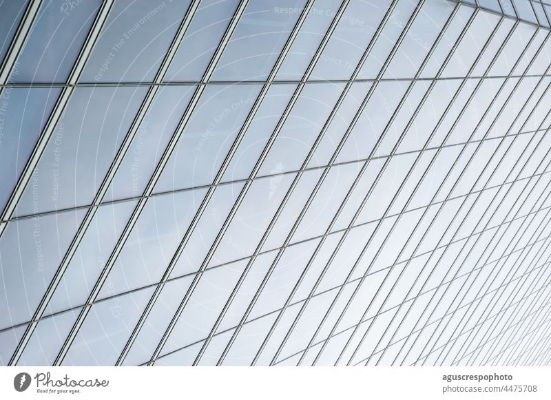 Semi-transparent glass windows of a skyscraper wall, seen from below. Background and symmetry madrid spain semitransparent glasses background exterior