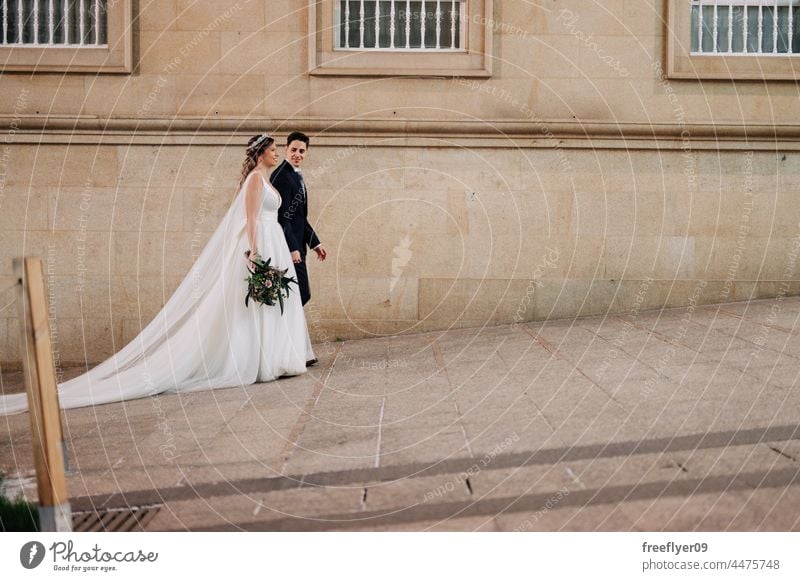 Couple on their wedding apparel walking by the street christmas vigo wife groom bride copy space winter night galicia spain lights decoration december couple