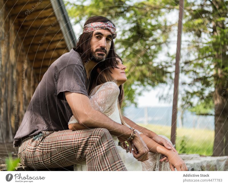 Couple on the stairs on the porch in front of the cabin couple relax hippie free happy love relationship emotion freedom hipster liberty lifestyles party