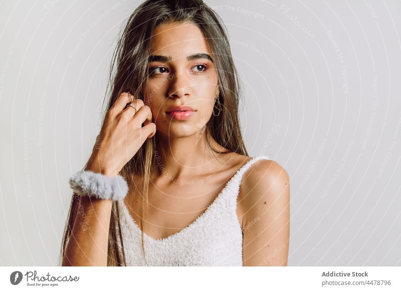 Crop contemplative ethnic model with brown hair and manicure reflective wistful sensitive emotionless natural beauty uncombed woman portrait grace appearance