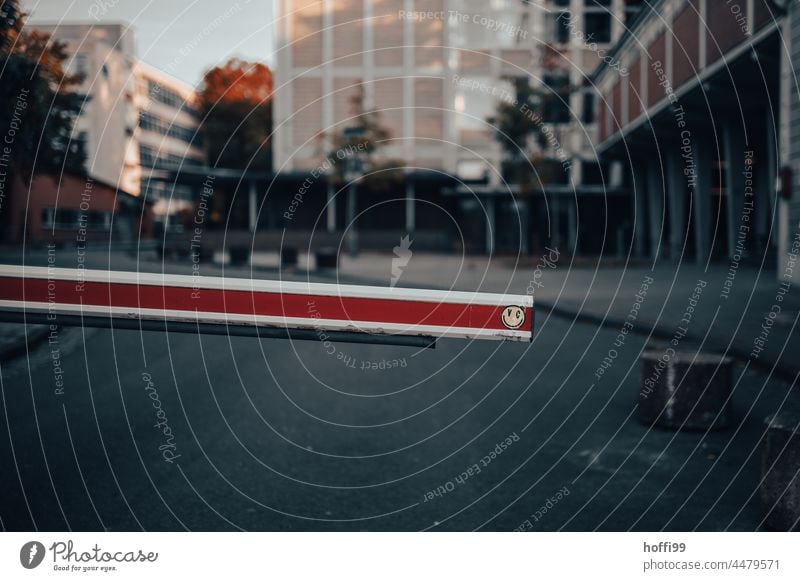 Barrier with smiley in front of a yard driveway Control barrier Red White red white Reddish white Transport cordon Bans Smiley Smiley face Safety Protection