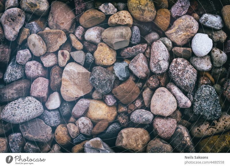 small colorful rocks and pebbles as a background. Stone texture, vintage style abstract backdrop backgrounds beach black coast covered decorative detail geology