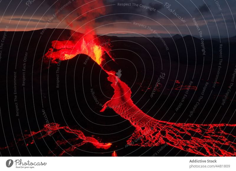 Red lava on volcanic surface magma night mountain nature volcano dark erupt flow highland iceland hot red terrain rough heat scenic stone obscure natural