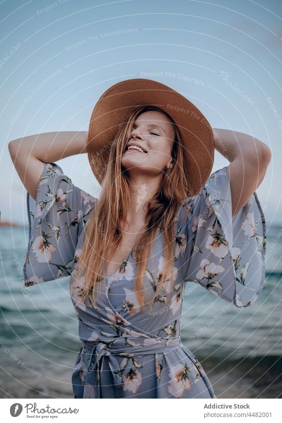 Woman in dress and hat woman evening sea seashore sunset summer delight happy female coast beach style joy trendy charming seaside smile nature seascape sundown