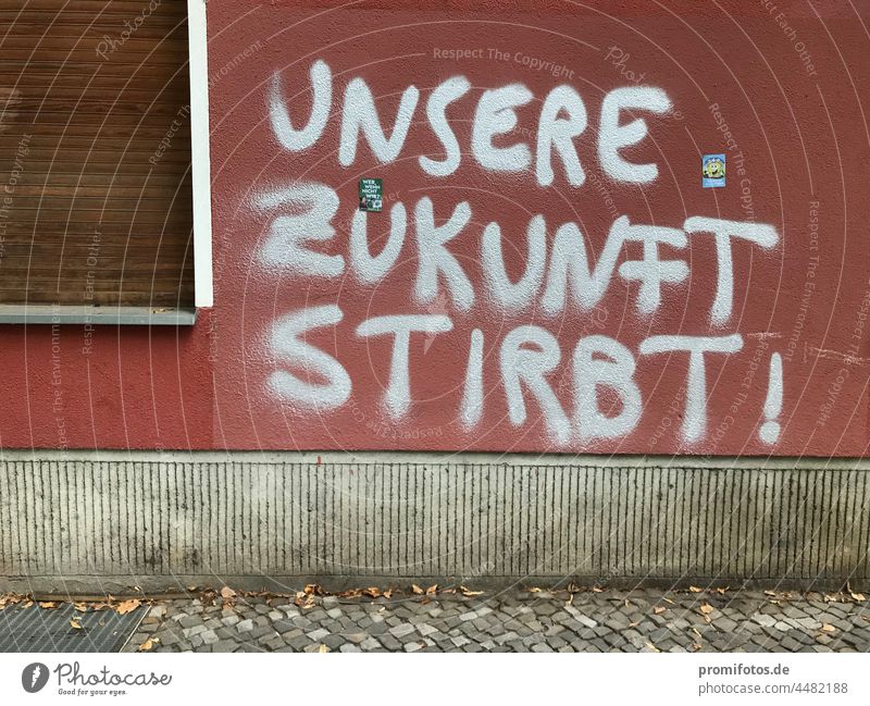 Graffiti on red house wall with window: "Our future is dying!" / Photo: Alexander Hauk Future Wall (building) Red Silver Window Closed Exterior shot daylight