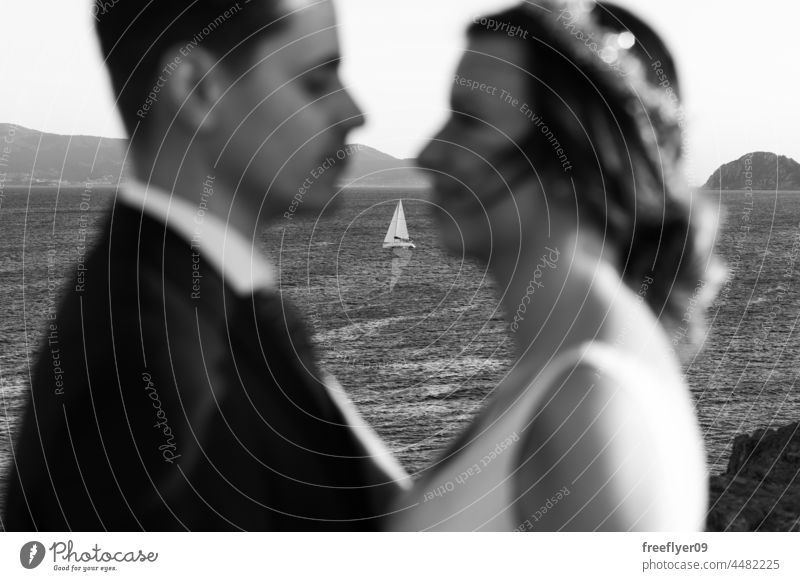 Defocused portrait of a just married couple against a boat wedding husband wife love copy space unfocused ocean heterosexual bride groom sunset lifestyle dress