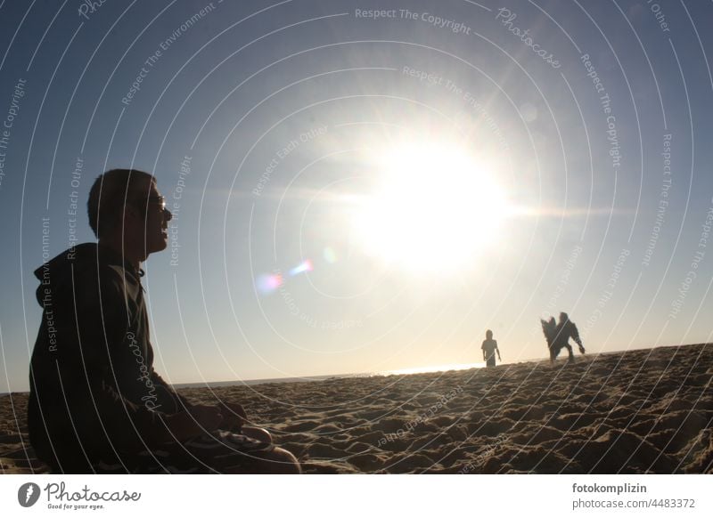 Man, child and dog on beach under glaring sun Child Dog Beach Sand ardor Sun Sandy beach Summer vacation Relaxation Vacation & Travel holidays Playing Movement