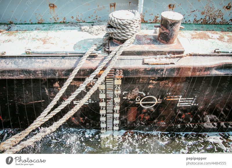 Always a hand's breadth of water under the keel - old, rusty ship lying in the harbour and fastened with an old rope Wake Keel Water Harbour Exterior shot