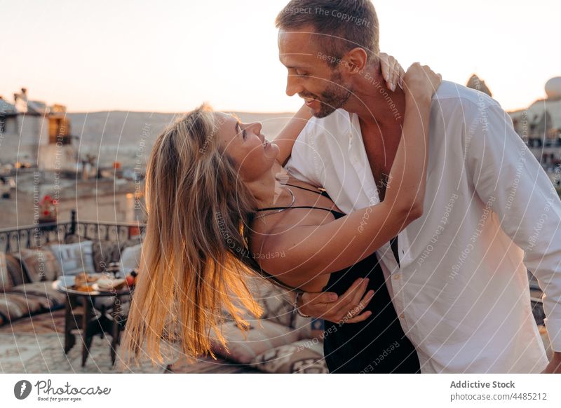 Couple dancing against flying hot air balloons couple dance soulmate rooftop date romantic together love relationship bonding weekend pleasure affection romance