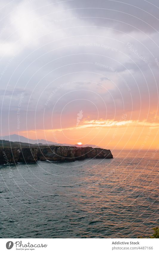 Rocky coast near rippling sea in Spain seashore sunset water seaside rock stone waterfront evening waterside seascape environment ripple scenery cloudy coastal