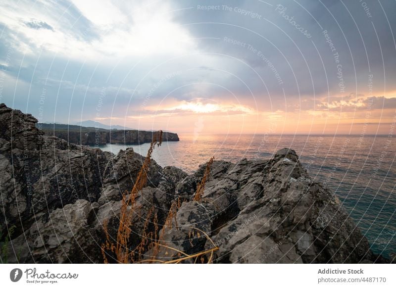 Rocky coast near rippling sea in Spain seashore sunset water seaside rock stone waterfront evening waterside seascape environment ripple scenery cloudy coastal