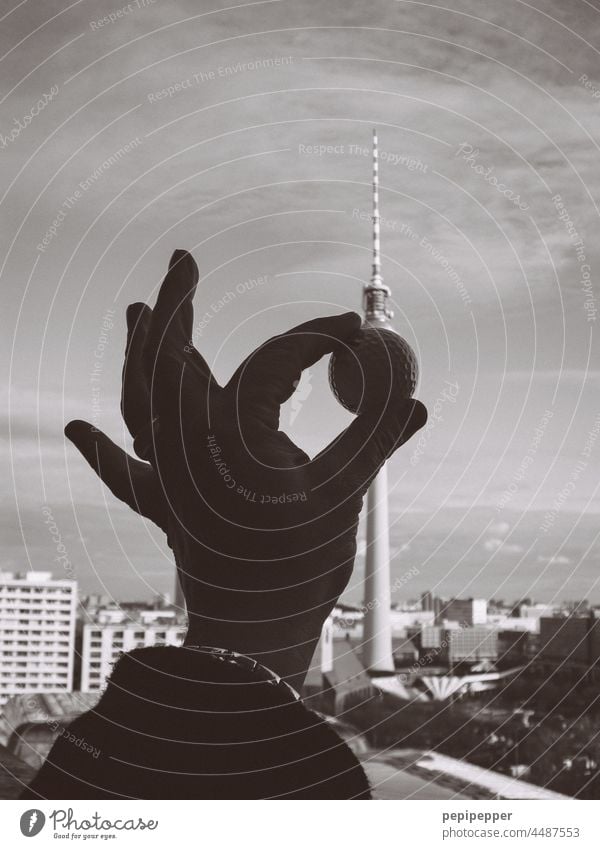 Golf ball in a hand held in front of the Berlin television tower Hand Handcrafts Television tower Television Tower Berlin Alexanderplatz alex experimental