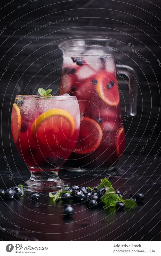 Lemonade with blueberries and lemon on table lemonade blueberry drink cold refreshment beverage glass jug citrus delicious slice vitamin natural flavor serve