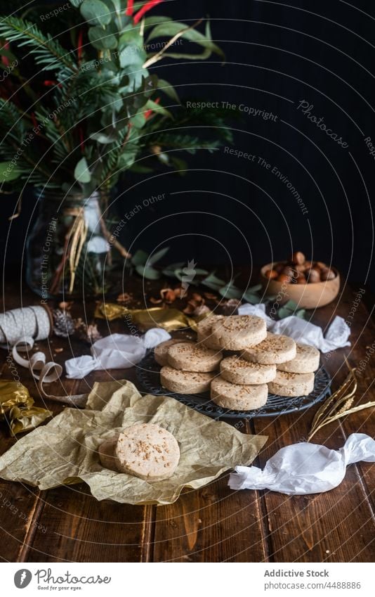 Delicious nut shortbread cookies on plate on table polvoron pile hazelnut christmas wrap paper dessert sweet dark food delicious celebrate festive holiday