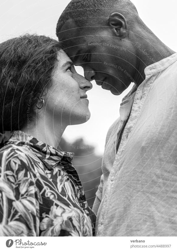 portrait of a diverse ethnics loving couple in black and white afro caucasian love family new order culture woman people smiling outdoors smile happiness summer