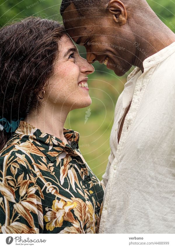 portrait of a diverse ethnics loving couple head to head in fall in the forest afro caucasian love family new order culture woman people smiling outdoors smile