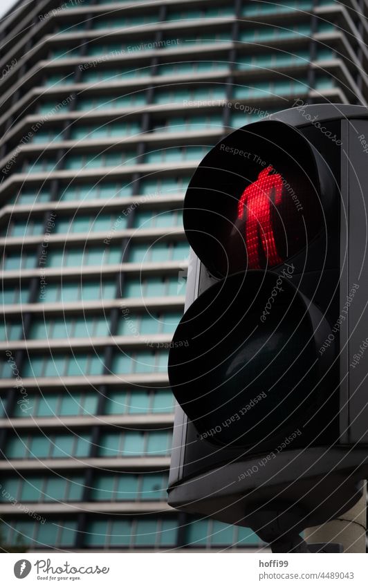 red traffic light for pedestrians in front of a high-rise building Red Traffic light ampelmännchen Pedestrian Road traffic Illuminate Pedestrian traffic light