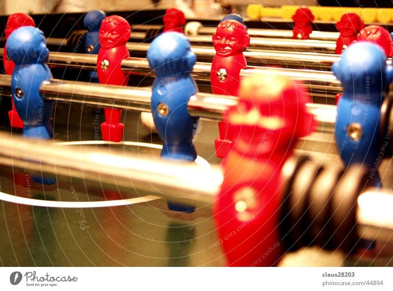 foosball devil Red Table soccer Macro (Extreme close-up) Close-up Sports Dynamics Blue Depth of field Rod Piece Playing field Colour photo