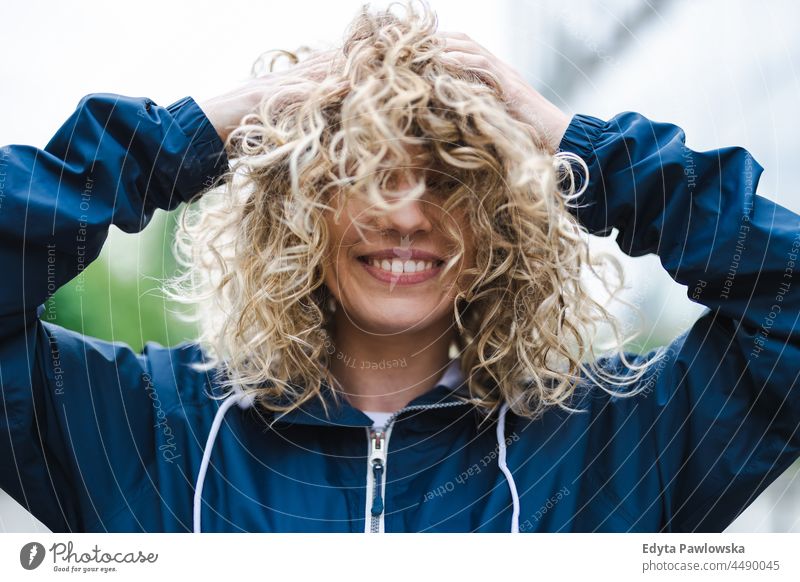 Portrait of laughing young woman outdoors Warsaw day fun curls hairstyle summer happiness tourist beauty smiling cheerful real people city life blond hair 20s