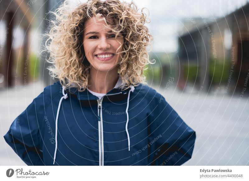 Portrait of young woman in the city Warsaw day fun curls hairstyle summer happiness outdoors tourist beauty smiling cheerful real people city life blond hair