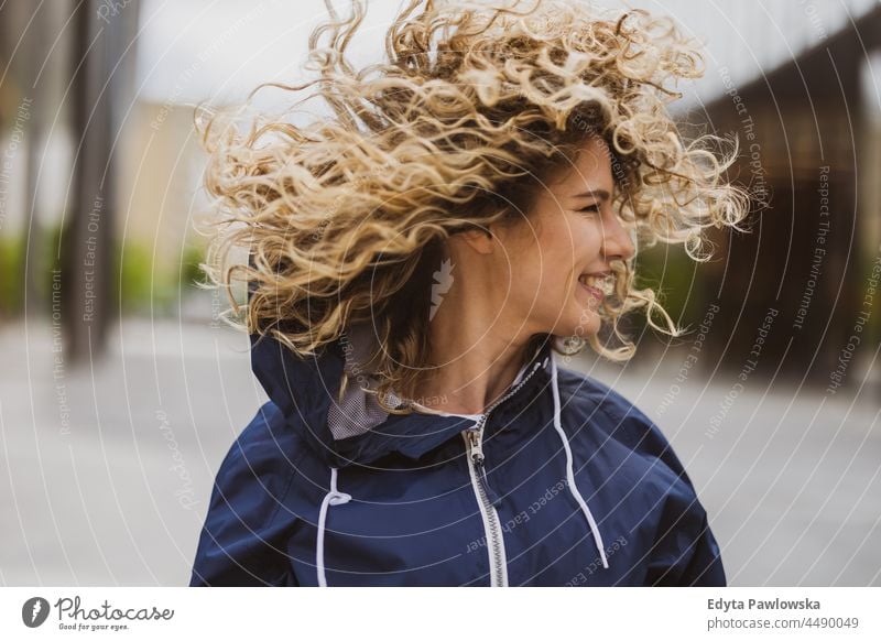 Portrait of laughing young woman outdoors Warsaw day fun curls hairstyle summer happiness tourist beauty smiling cheerful real people city life blond hair 20s