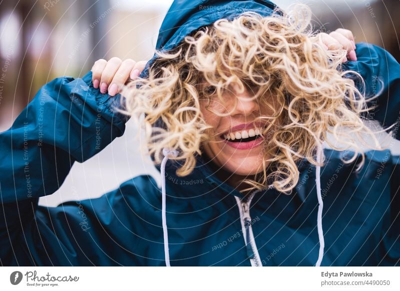 Portrait of laughing young woman outdoors Warsaw day fun curls hairstyle summer happiness tourist beauty smiling cheerful real people city life blond hair 20s