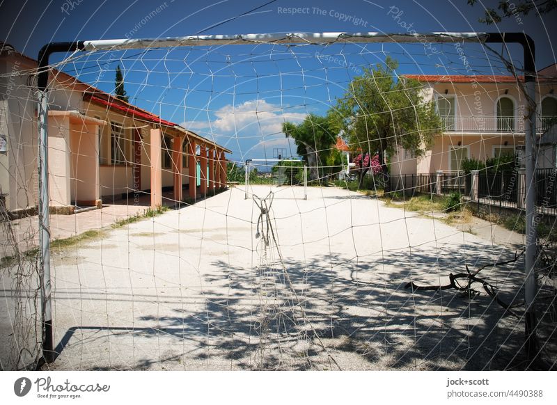 abandoned football field of a holiday resort at the end of the season Football pitch amateur football field Leisure and hobbies Net Sunlight Shadow