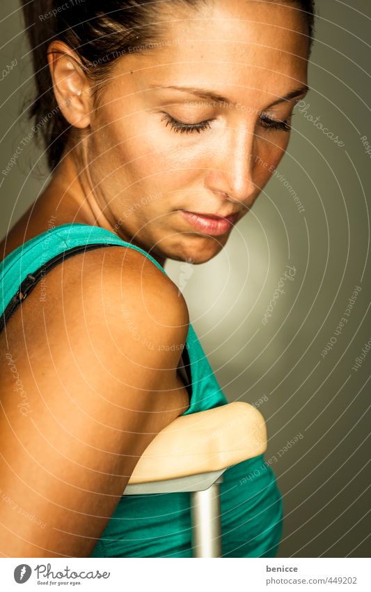 Young woman with crutches Woman Human being Accident Walking aid Dress green Blue Studio shot Breasts Upper body Fracture Handicapped Patient Hospital