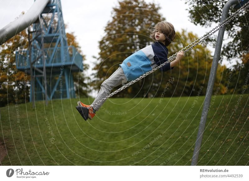 Child swinging on a playground Swing Infancy Children's game Boy (child) naturally Happy Joy Playground swinging is like flying To swing Playing