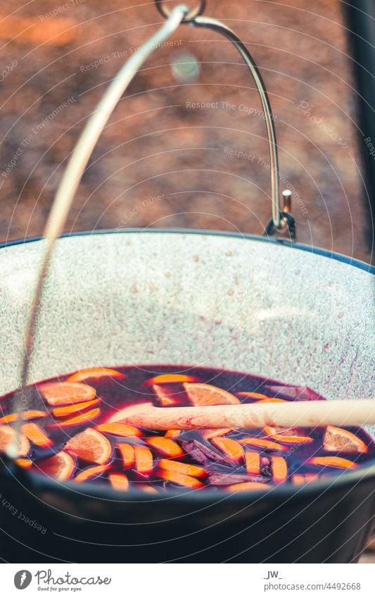 Mulled wine with orange pieces in a large pot over the campfire Punch Pot Christmas & Advent Colour photo Winter Hot drink Close-up Beverage