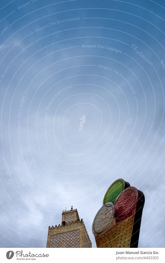 Mosque in Morocco next to ice cream billboard symbolic faith perspective look creativity message play advertising association perception tower mean observe