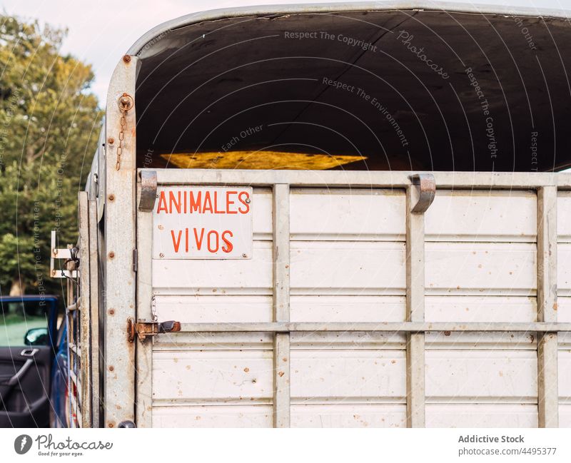 Metal livestock trailer parked on road transport countryside aged farm metal auto camper trip tree path daytime cage door close old vehicle spain truck farmland