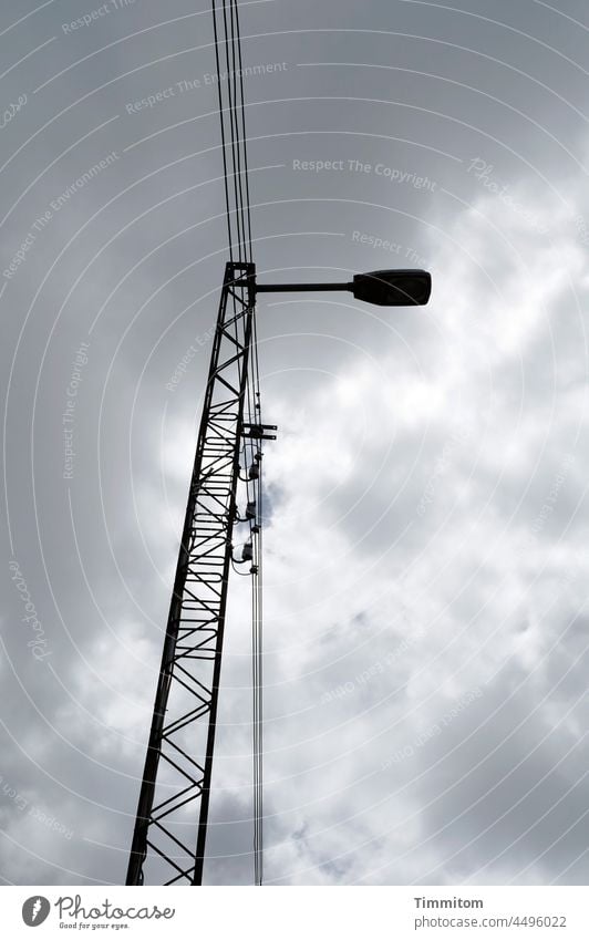 Lamp looking down Pole Cable Cables Transmission lines Electricity Electricity pylon Energy industry Clouds Exterior shot Deserted Light