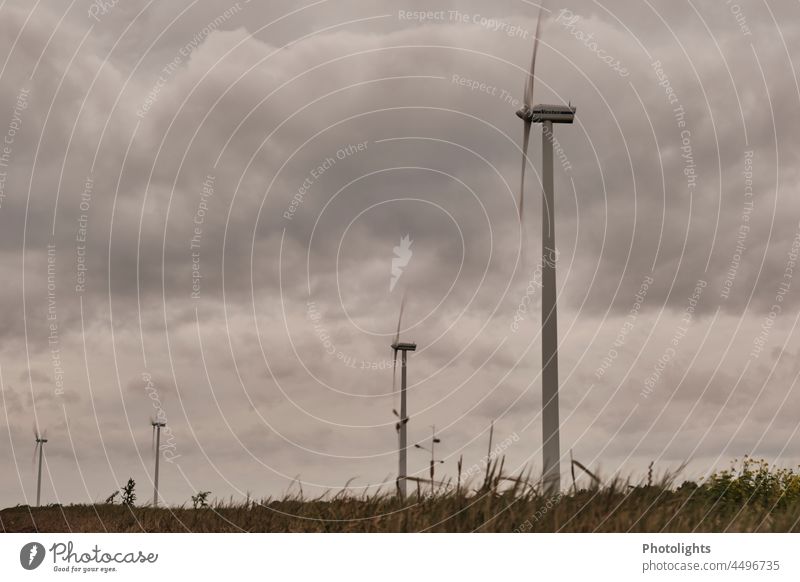 Growian / large wind turbines in front of dark clouds growian Large Propeller Wind energy plant Rotor Double-winged Energy industry Electricity Renewable energy