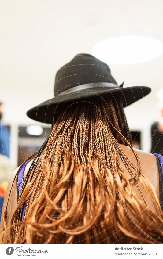 Anonymous black woman with braids standing on street style hairstyle appearance trendy fashion city sunlight holiday daytime apparel female african american