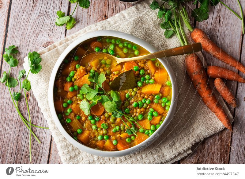 Curry with green peas and vegetables curry meal food basil cuisine healthy food dish carrot delicious organic portion serve bowl pot spoon wooden tasty