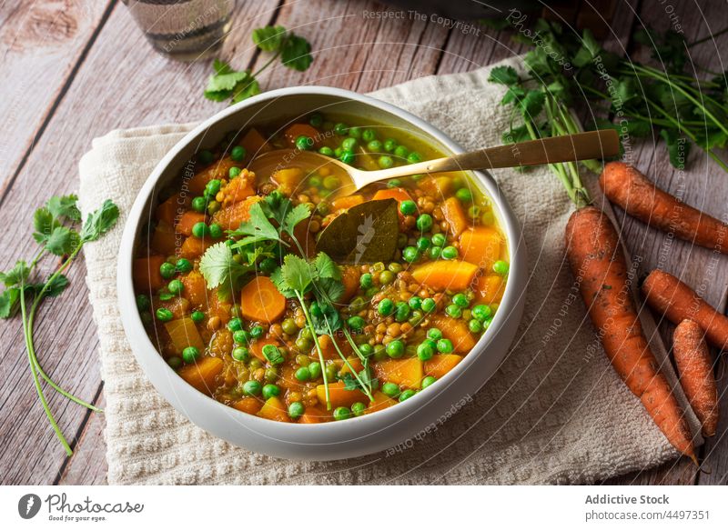 Curry with green peas and vegetables curry meal food basil cuisine healthy food dish carrot delicious organic portion serve bowl pot spoon wooden tasty