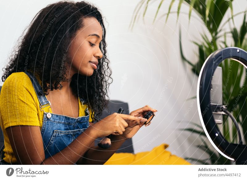 Woman demonstrating cosmetics during video conversation via smartphone woman video call demonstrate video chat beauty ring lamp using illuminate influencer vlog